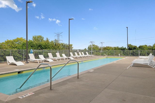 pool featuring a patio and fence