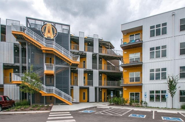 view of building exterior with uncovered parking