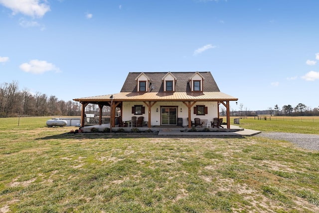 farmhouse with a front yard, a porch, and metal roof