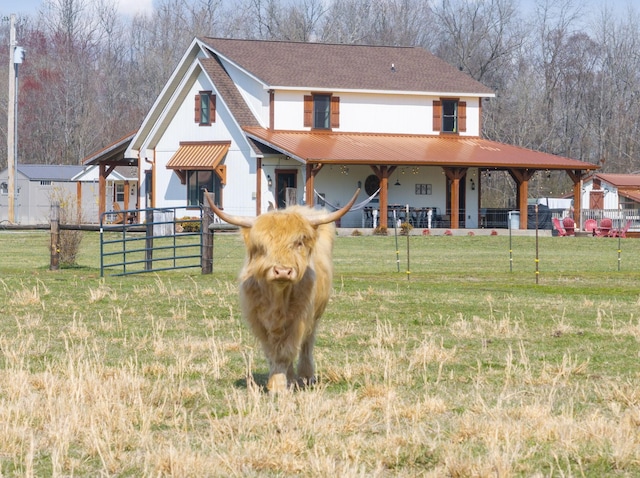 view of front of home with an exterior structure, metal roof, and an outbuilding