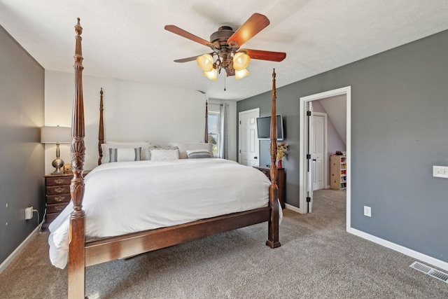 carpeted bedroom with visible vents, baseboards, and a ceiling fan