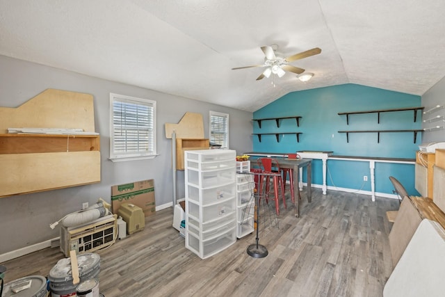 recreation room featuring vaulted ceiling, baseboards, a ceiling fan, and wood finished floors