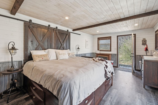 bedroom featuring a barn door, beam ceiling, dark wood-type flooring, and wood ceiling