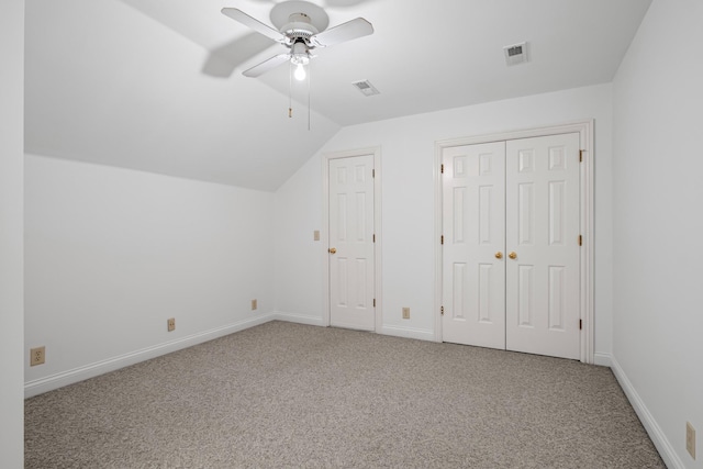 additional living space with visible vents, baseboards, vaulted ceiling, carpet flooring, and a ceiling fan