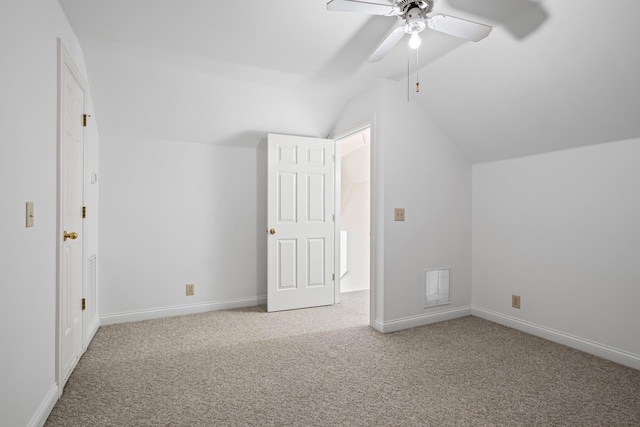 additional living space featuring a ceiling fan, baseboards, carpet floors, visible vents, and vaulted ceiling