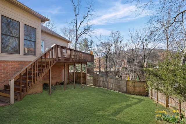 view of yard with stairs, a deck, and a fenced backyard