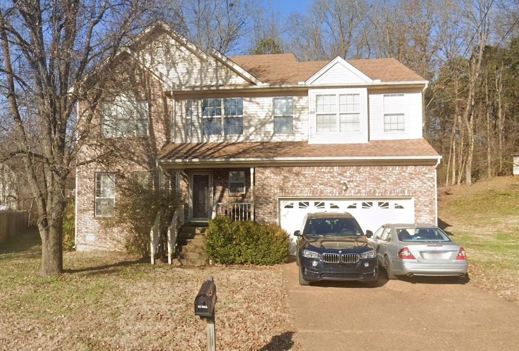 2337 Willesden Green Ct, Hermitage, TN 37076 - traditional-style house featuring an attached garage, driveway, a front lawn, and brick siding