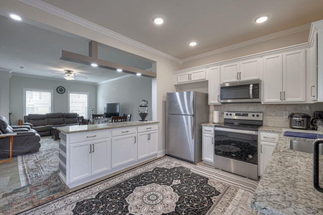 105 David Bolin Dr, La Vergne, TN 37086 - kitchen with white cabinetry, a peninsula, open floor plan, and stainless steel appliances