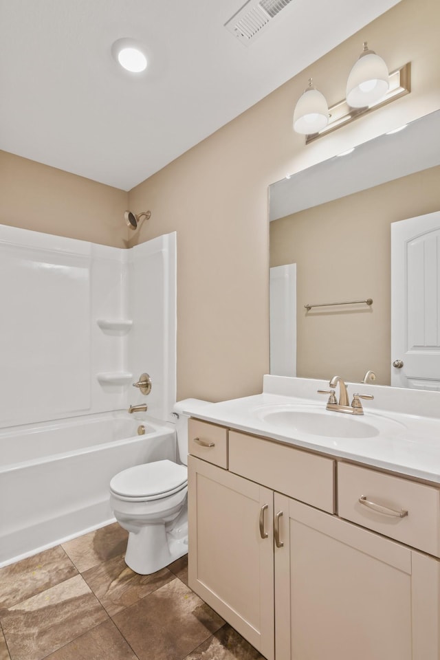 full bath with visible vents, toilet, vanity, and bathtub / shower combination