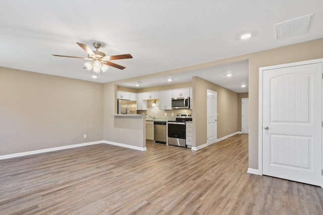 unfurnished living room with visible vents, recessed lighting, light wood finished floors, baseboards, and ceiling fan