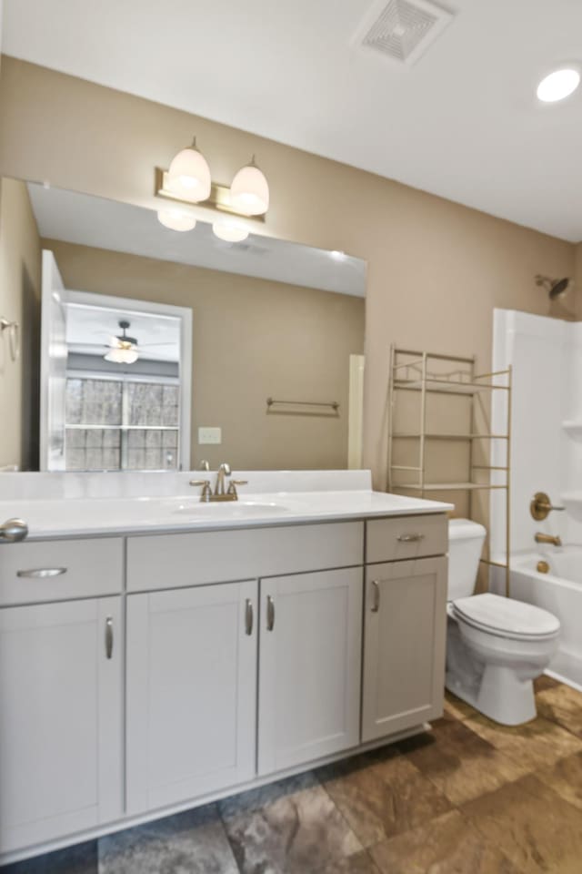 full bath featuring visible vents, toilet, vanity, and shower / bathtub combination