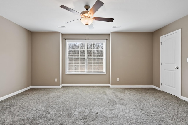 unfurnished room with visible vents, carpet floors, and a ceiling fan