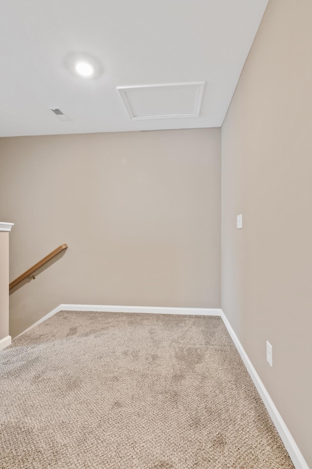 carpeted empty room featuring visible vents and baseboards