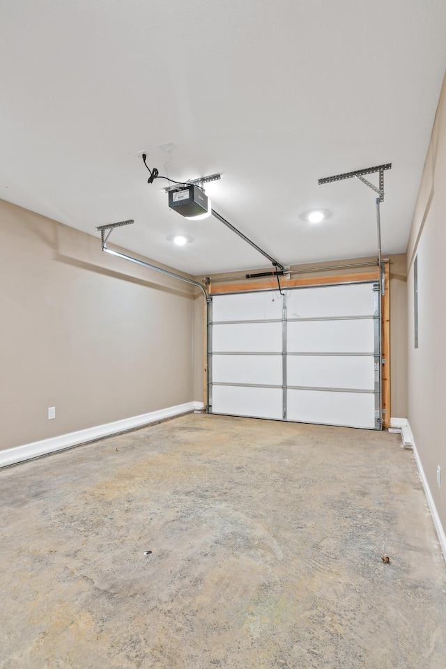 garage with a garage door opener and baseboards
