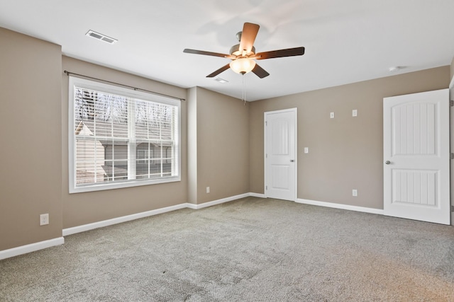 unfurnished bedroom featuring ceiling fan, carpet, visible vents, and baseboards