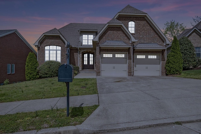 2821 Brentwood Knoll Ct, Nashville, TN 37211 - french country inspired facade featuring brick siding, driveway, a front yard, and an attached garage