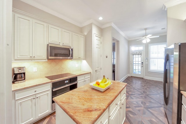 1007 State Blvd, Franklin, TN 37064 - kitchen featuring black appliances, ceiling fan, backsplash, ornamental molding, and a center island