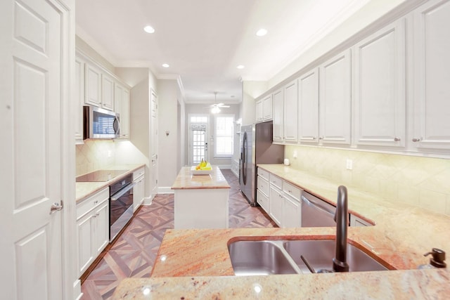 1007 State Blvd, Franklin, TN 37064 - kitchen featuring appliances with stainless steel finishes, ornamental molding, a kitchen island, white cabinets, and recessed lighting