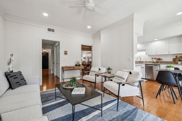 102 Foxborough Sq W, Brentwood, TN 37027 - living area with visible vents, crown molding, light wood-type flooring, and a ceiling fan