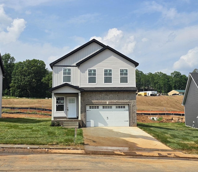 176 Cardinal Crk, Clarksville, TN 37040 - view of front of house with a garage, brick siding, a front yard, concrete driveway, and board and batten siding