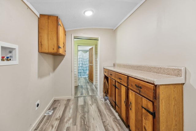 laundry room with washer hookup, baseboards, electric dryer hookup, cabinet space, and light wood-style flooring