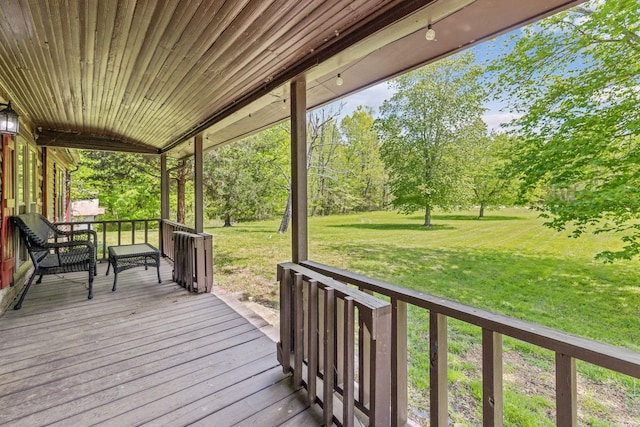 wooden terrace with a lawn
