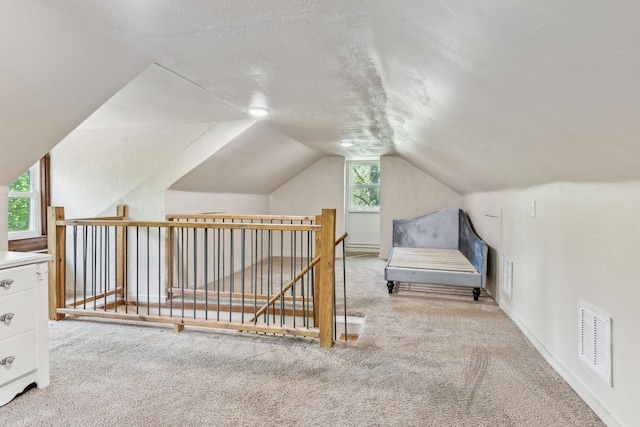 bonus room featuring vaulted ceiling, visible vents, and carpet flooring