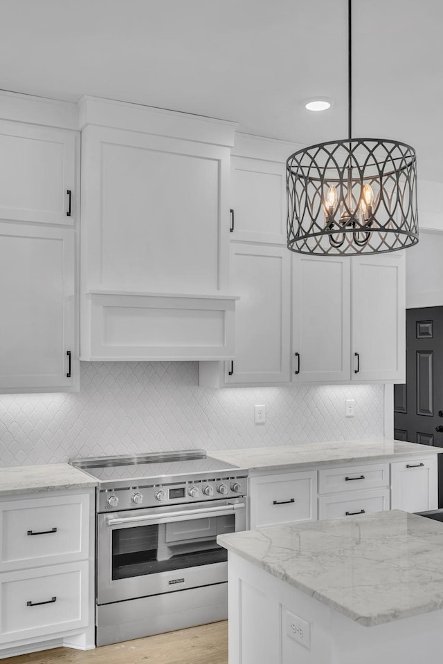 184 Emma Ln, Hohenwald, TN 38462 - kitchen featuring a notable chandelier, white cabinets, stainless steel electric stove, and tasteful backsplash