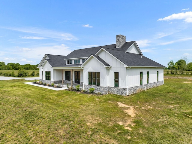184 Emma Ln, Hohenwald, TN 38462 - view of front of house featuring roof with shingles, board and batten siding, and a front yard
