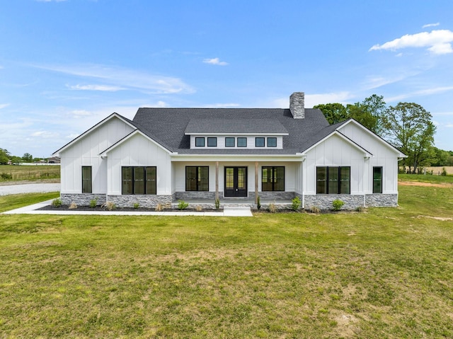 184 Emma Ln, Hohenwald, TN 38462 - modern farmhouse style home with a front lawn, stone siding, french doors, roof with shingles, and board and batten siding