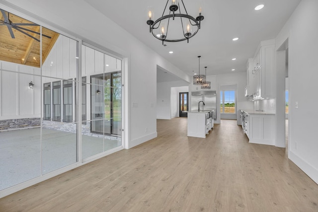 184 Emma Ln, Hohenwald, TN 38462 - unfurnished living room with an inviting chandelier, light wood-style flooring, recessed lighting, and baseboards