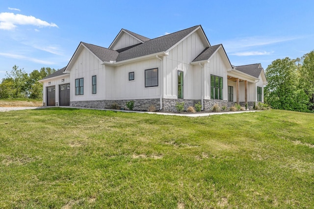 184 Emma Ln, Hohenwald, TN 38462 - view of side of home with stone siding, a yard, board and batten siding, a shingled roof, and a garage