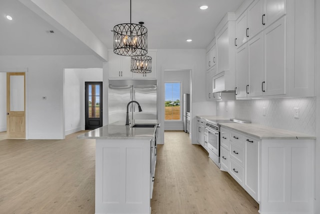 184 Emma Ln, Hohenwald, TN 38462 - kitchen featuring a center island with sink, high quality appliances, light wood-style flooring, a notable chandelier, and tasteful backsplash
