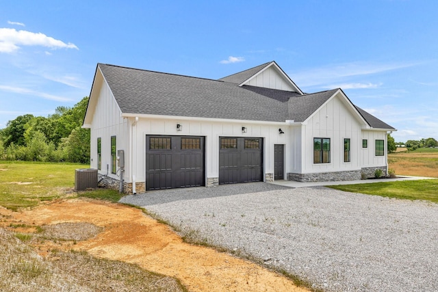 184 Emma Ln, Hohenwald, TN 38462 - view of side of property with board and batten siding, a shingled roof, cooling unit, a garage, and driveway