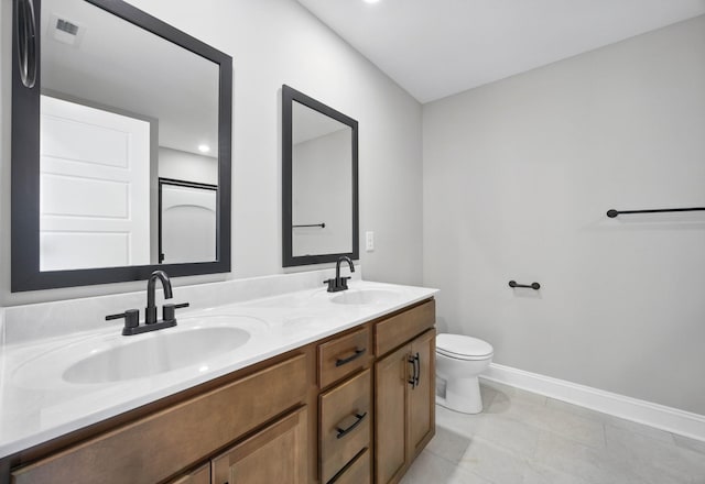 151 Cardinal Crk, Clarksville, TN 37040 - bathroom with double vanity, toilet, baseboards, and tile patterned floors