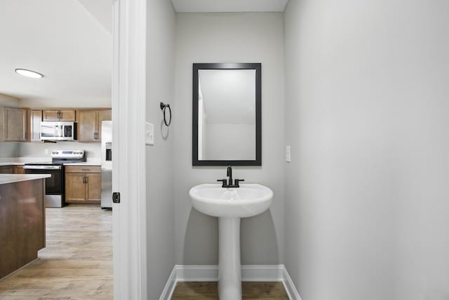 151 Cardinal Crk, Clarksville, TN 37040 - bathroom with wood finished floors, baseboards, and a sink
