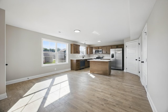 151 Cardinal Crk, Clarksville, TN 37040 - kitchen featuring stainless steel appliances, baseboards, light countertops, open floor plan, and a kitchen island