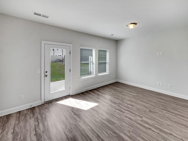 interior space featuring visible vents, baseboards, and wood finished floors