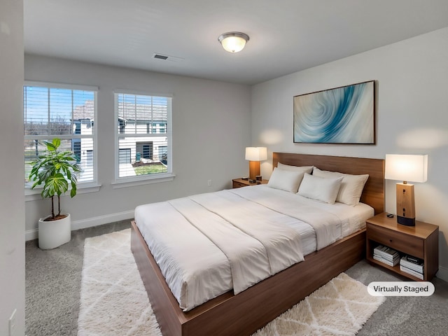 bedroom featuring carpet, visible vents, and baseboards