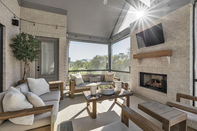 sunroom with an outdoor living space with a fireplace