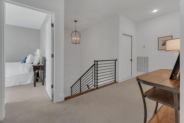 hall with recessed lighting, an upstairs landing, a notable chandelier, visible vents, and carpet floors