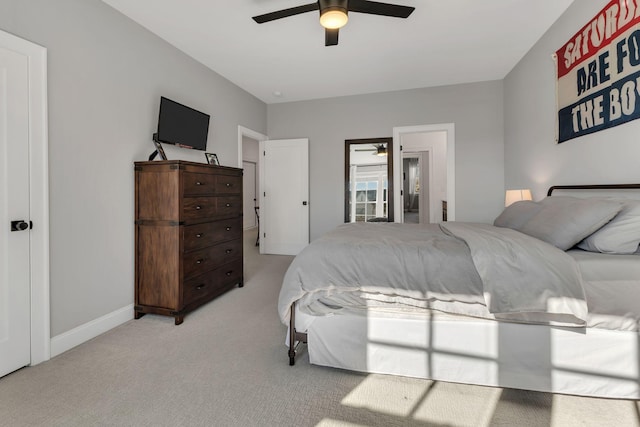 bedroom featuring baseboards, a ceiling fan, and light carpet