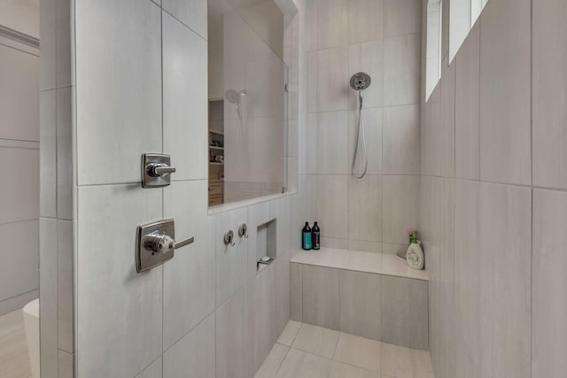 bathroom featuring tile walls and tiled shower