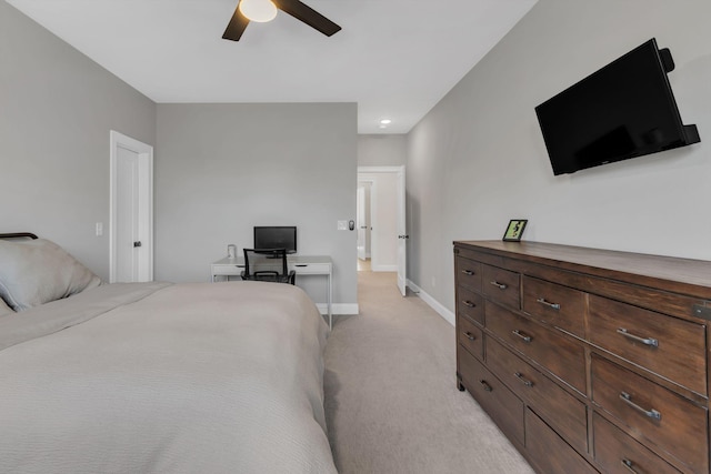 bedroom with ceiling fan, light carpet, and baseboards