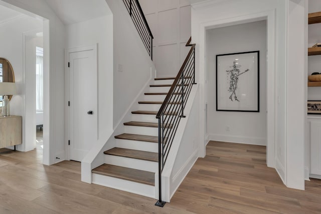 stairs featuring baseboards and wood finished floors