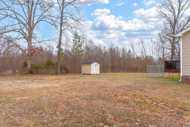 view of yard with an outbuilding, a deck, and a shed