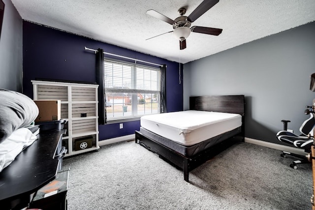 carpeted bedroom with a textured ceiling, baseboards, and ceiling fan