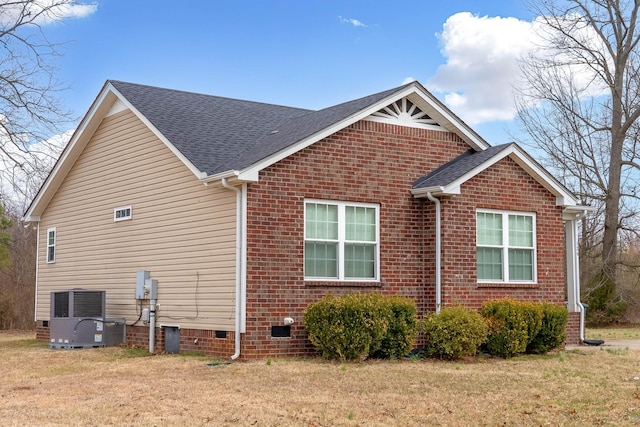 view of home's exterior featuring roof with shingles, crawl space, central AC, and a lawn