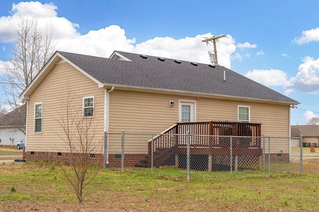 rear view of house featuring a shingled roof, crawl space, a deck, and a lawn