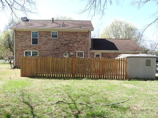 203 Valleydale St, Smyrna, TN 37167 - rear view of house with a yard, brick siding, and fence